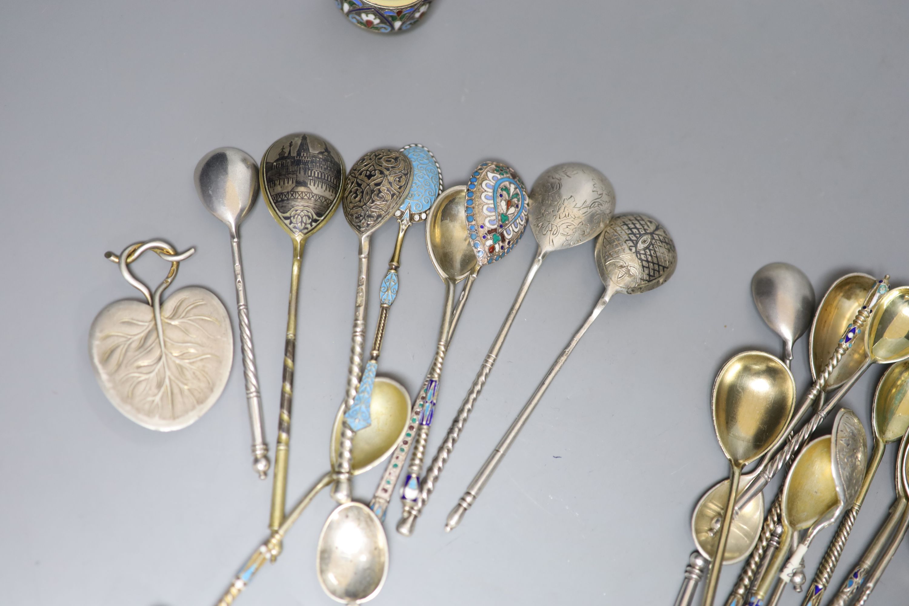 A small collection of Russian and Russian style white metal spoons etc, some with enamel or niello decoration.
